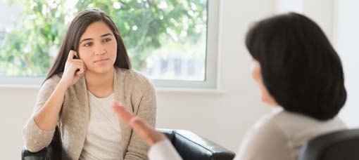 Young girl talking to therapist