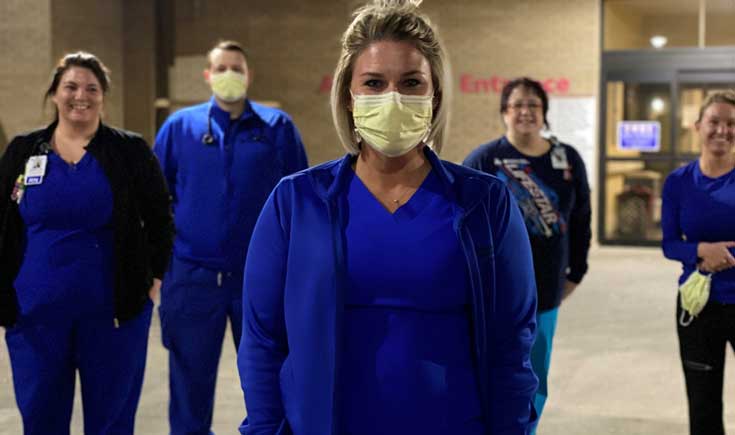 Northwest Texas Healthcare System Nurses wearing masks in front of hospital entrance